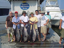 3 men holding their fishing catch in va beach